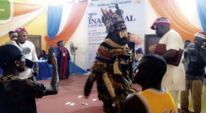 Arondizuogu masquerader entertaining the participants at the lecture.