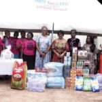 Founder and CEO of WACCA presenting gift items to vulnerable children at FSP Children’s Home, Enugu