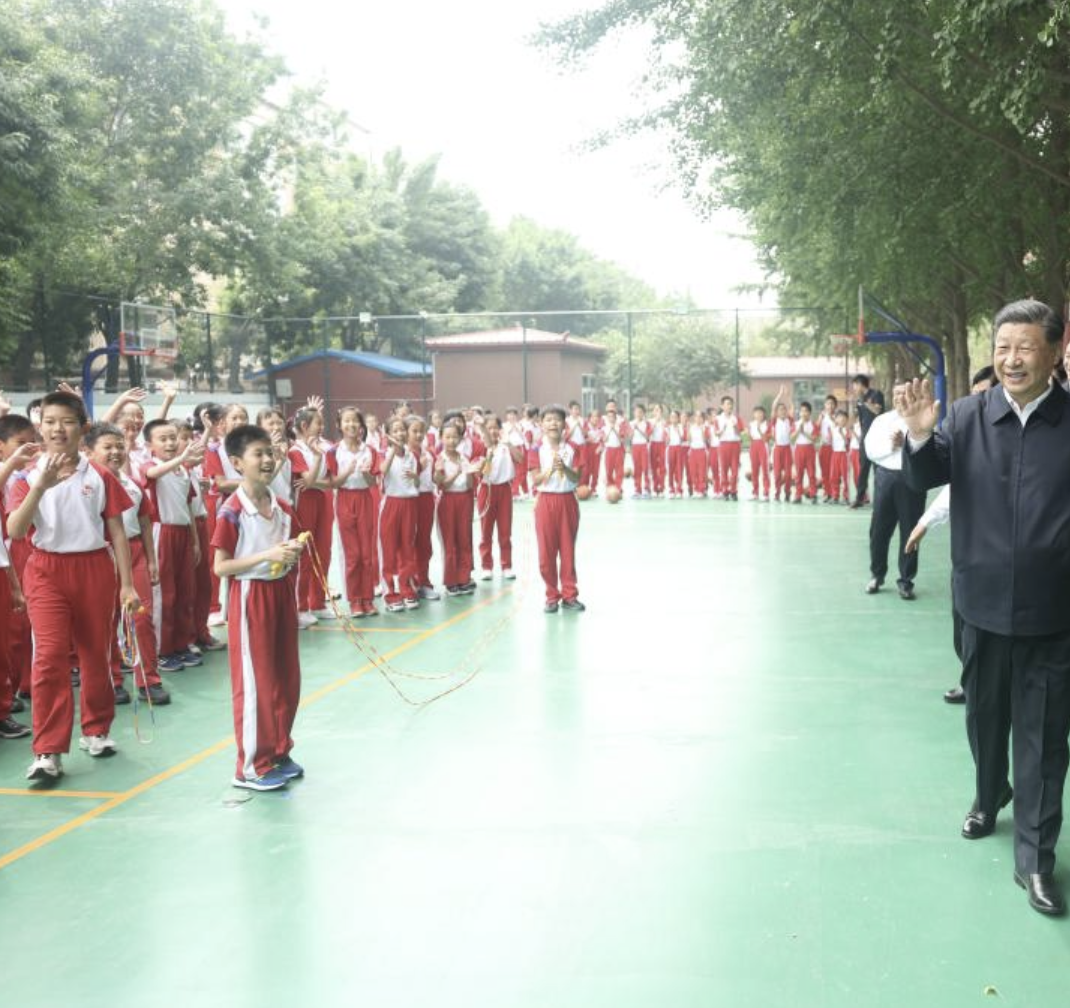 Chinese President Xi Jinping, also general secretary of the Communist Party of China Central Committee and chairman of the Central Military Commission, greets students on the basketball court of Beijing Yuying School in Beijing, May 31, 2023. /Xinhua