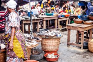 Lagos, Nigeria: Local women selling fresh fish at seafood market in Makoko area – called White Market.