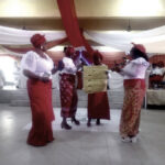 Women groups recite Voices of Motherhood during the programme