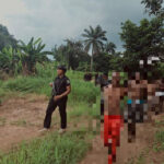 Policemen leading the suspects out from the forest