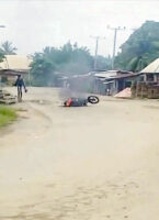 •A motorcycle on fire during the incident.