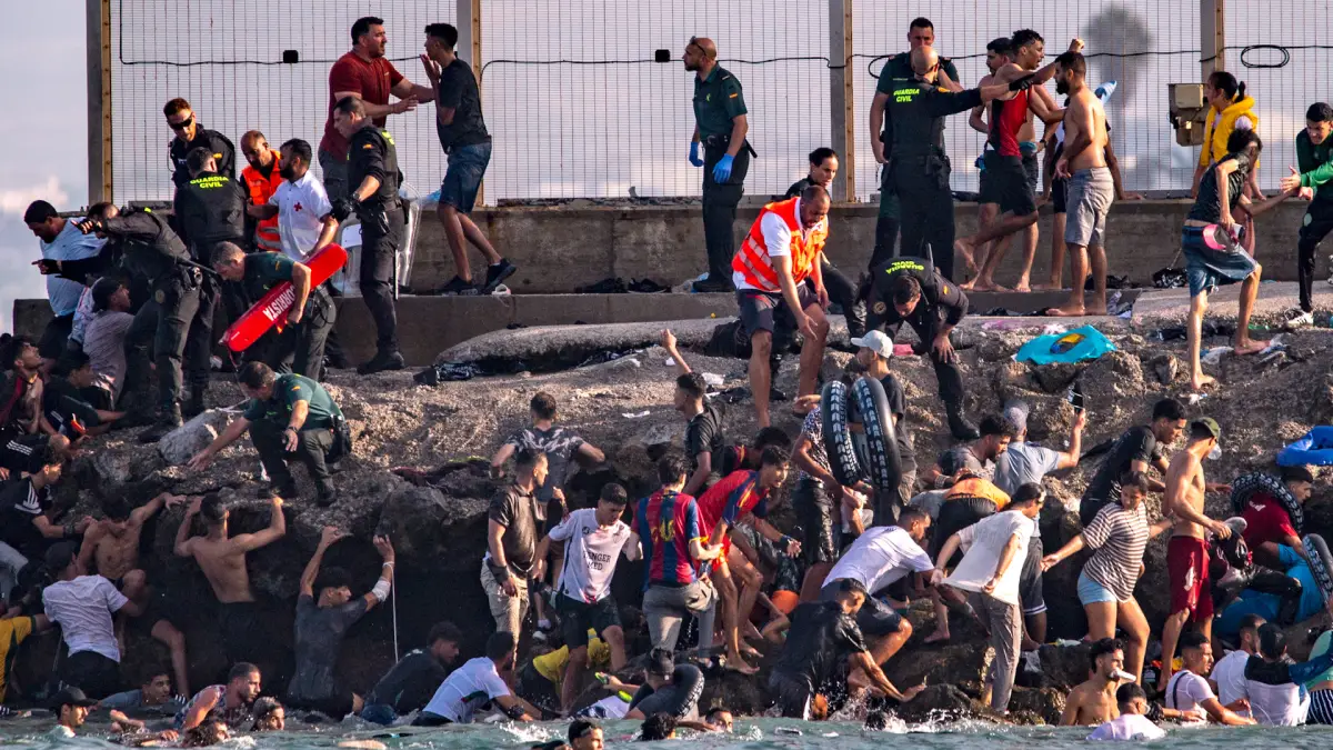 Thousands of migrants cross from Morocco into Spain’s Ceuta enclave
