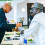 Governor Eno receiving award from Ndaji Alhassan, Registrar of NANNIM at Government House, Uyo