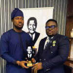 Ekweoba (left) receiving the Nelson Mandela Impact Award