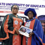 Olaleye (right) presenting copy of the inaugural lecture to Lafiaji-Okun eye