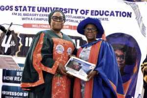 Olaleye (right) presenting copy of the inaugural lecture to Lafiaji-Okun eye