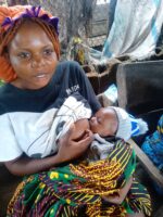 Mrs Iember Ati breastfeeding her baby in the market