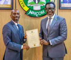 Mr. Olusegun Omosehin, Commission for nsurance (right), presenting the new operational licence to Mr. Babatunde Fajemirokun, the MD/CEO of AIICO Insurance Plc