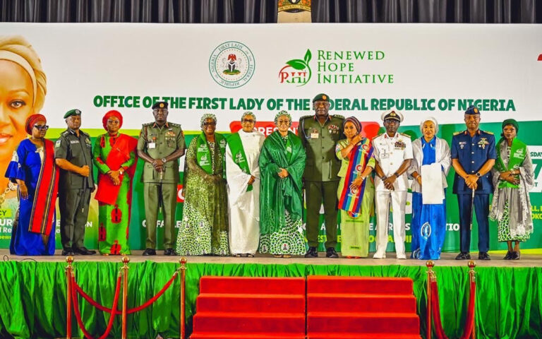 L-R Wife of the Inspector General of Police, Mrs Mutiat Disu, IGP Tunji Disu, Representative of the Wife of the Chief of Army Staff, Mrs Safiyyah Shaibu, Chief of Army Staff, Lt. General Waidi Shaibu, Wife of the Senate President, Mrs Ekaette Akpabio, Wife of the Vice President, Hajia Nana Shettima, First Lady of Nigeria, Senator Oluremi Tinubu, Chief of Defence Staff, General Olufemi Oluyede, his wife, Mrs Mernan Oluyede, Chief of Naval Staff, Vice Admiral Idi Abass, his wife Mrs Aisha Abass, Chief of Air Staff, Air Vice Marshall Aneke and the Wife of the Chief of Staff to the President, Mrs Salamatu Gbajabiamila after the presentation of cheques from the Renewed Hope Initiative by the First Lady held at the State House Banquet Hall Abuja on Thursday 27th August 2026