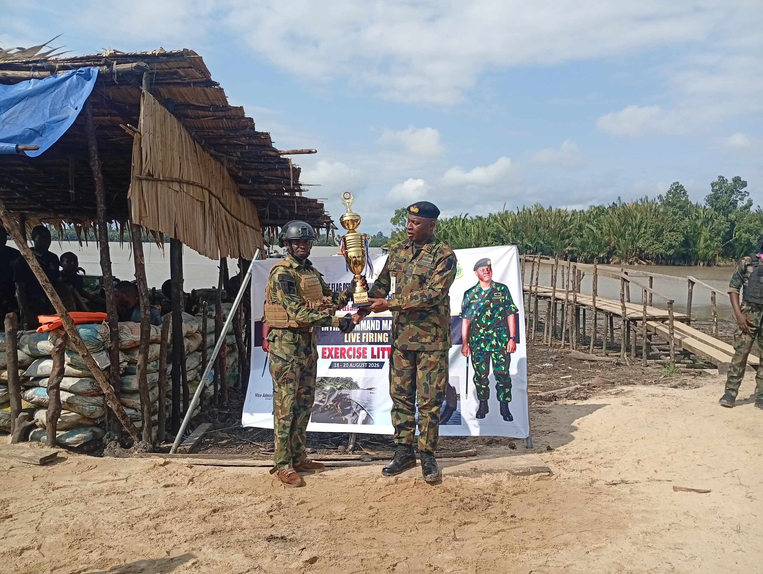 Rear Admiral Suleiman Ibrahim (right) presenting the overall price to LSFCI Gbaranwi Kingsley, captain of the FOB, Bonny